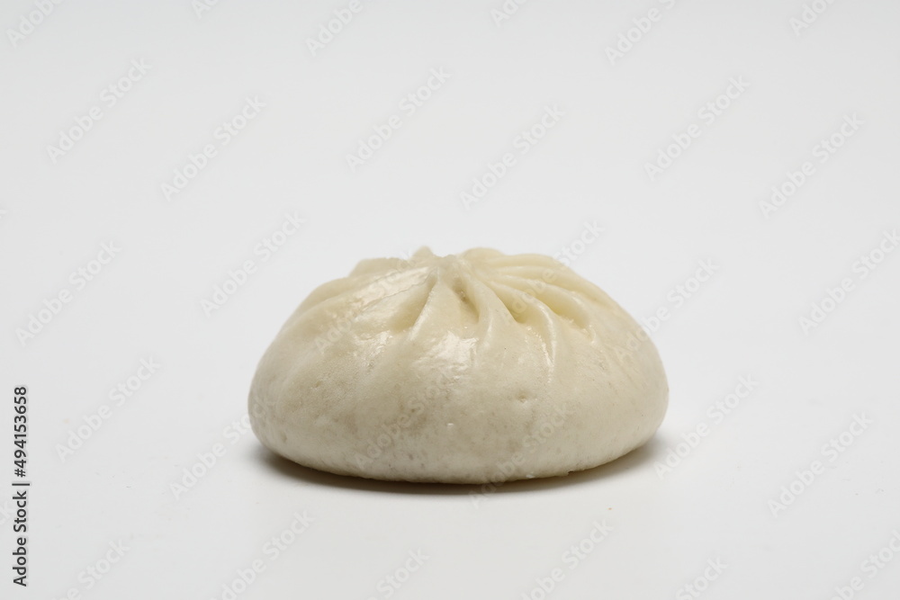 Delicious baozi, Chinese steamed meat bun is ready to eat on serving plate and steamer, close up, copy space product design concept. Delicious baozi, Chinese steamed meat bun is ready to eat on serving plate and steamer, close up, copy space product design concept.
