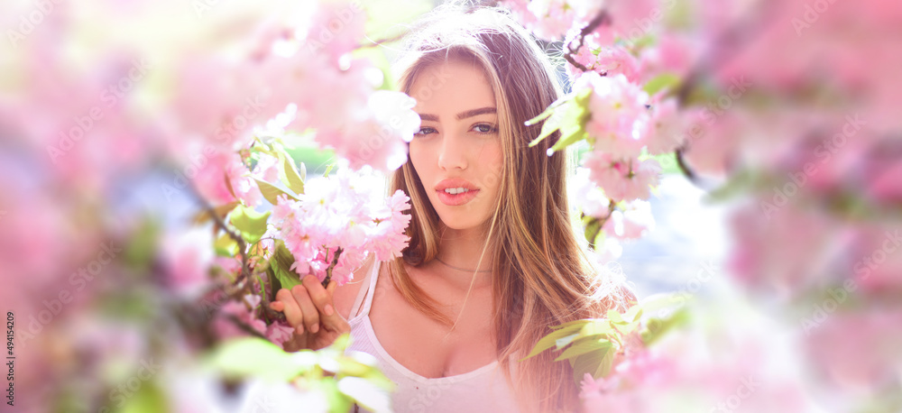 Beauty spring woman face. Happy beautiful young girl relaxing in blossom park. Banner for header website design, copy space.