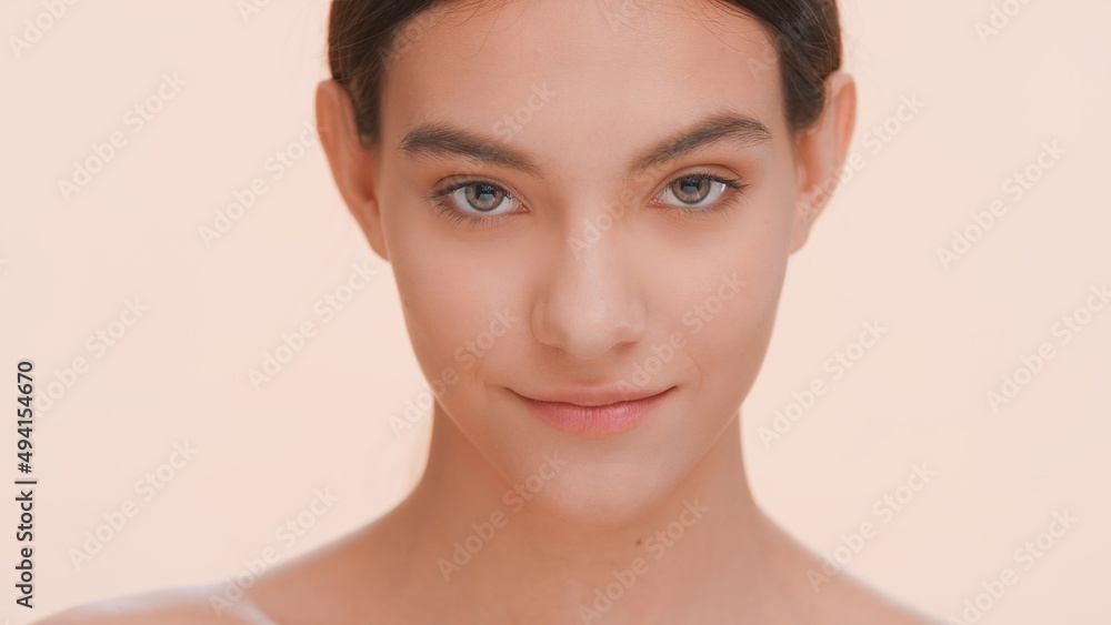 Close-up studio portrait of a positive beauty model. Young woman looks at the camera | Beauty care and skincare concept. Close-up studio portrait of a positive beauty model. Young woman looks at the camera | Beauty care and skincare concept.