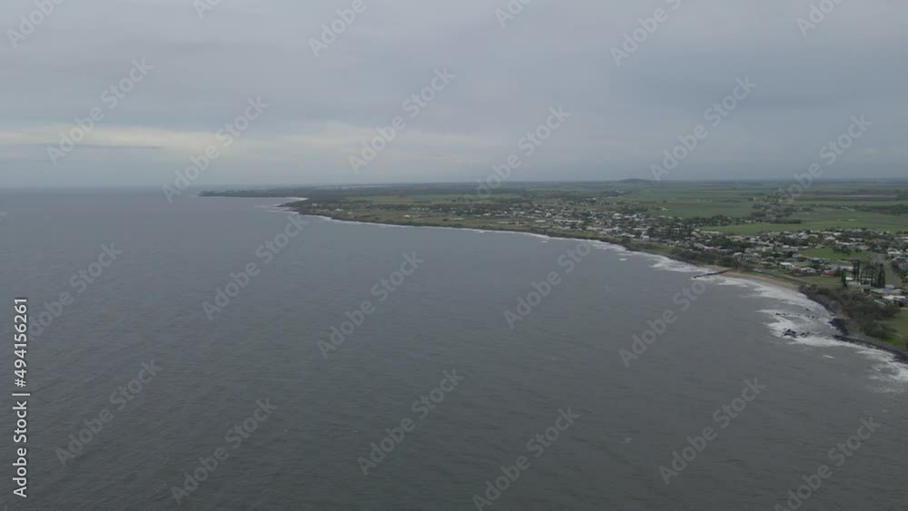 Rocky Shoreline Of Burnett Heads With Oaks Beach In Bundaberg, Queensland, Australia. - aerial Rocky Shoreline Of Burnett Heads With Oaks Beach In Bundaberg, Queensland, Australia. - aerial