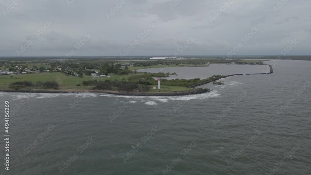 Ocean Waves Hitting The Shoreline Of Burnett Heads Lighthouse In Bundaberg Region, QLD, Australia. - aerial Ocean Waves Hitting The Shoreline Of Burnett Heads Lighthouse In Bundaberg Region, QLD, Australia. - aerial