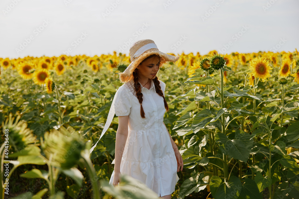 woman with pigtails in a field of sunflowers lifestyle unaltered