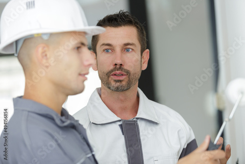 painting supervisor talking to colleague