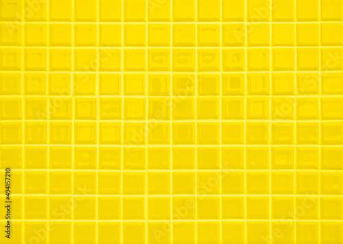 Yellow ceramic wall and floor tile abstract background. Design geometric mosaic texture for backdrop hospital wall, canteen and kitchen.