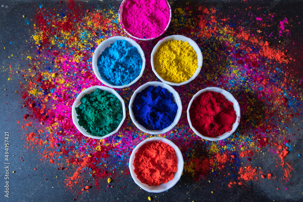 Gulal or holi colors in bowls on a background with use of selective focus 
