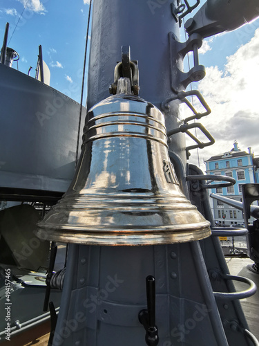 Russia, St. Petersburg - August 2020. The bell on the cruiser Aurora and the Nakhimov School in the background photo