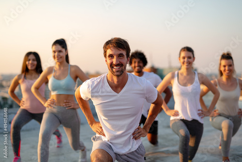 Fitness sport friendship and healthy lifestyle concept. Group of happy friends or people exercising photo