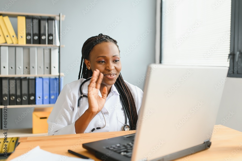 African female doctor talk with patient make telemedicine online webcam video call. Woman therapist videoconferencing on computer in remote telemedicine laptop virtual chat. Telehealth concept African female doctor talk with patient make telemedicine online webcam video call. Woman therapist videoconferencing on computer in remote telemedicine laptop virtual chat. Telehealth concept