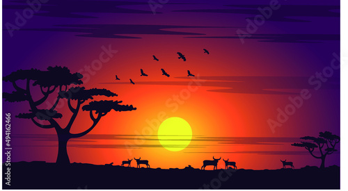 African sunset with tree, birds, rams silhouette.