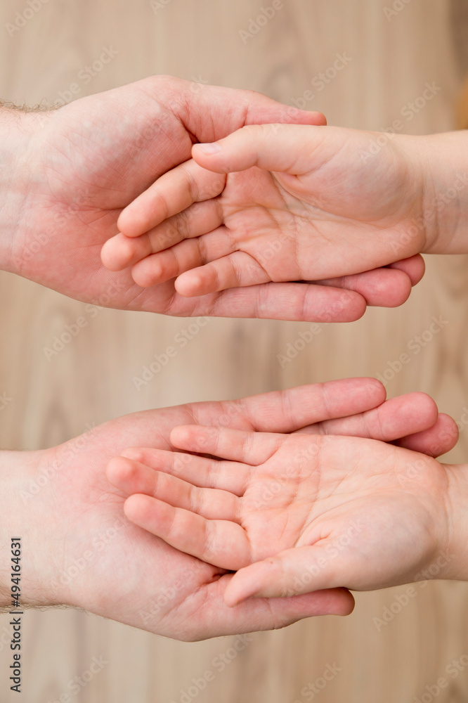 Kids hands in the fathers palms. Parenting, friendship, guardianship, upbringing, parent-child relationship, family connection. Kids hands in the fathers palms. Parenting, friendship, guardianship, upbringing, parent-child relationship, family connection.