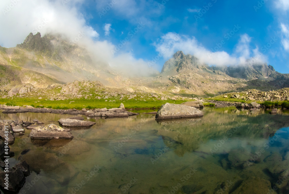 Lakes formed when the snow melted in a spring weather with white clouds in the blue sky. Lakes formed at the summit. Kackar Mountains. Verçenik Gate Lakes. Rize, Turkey.