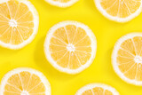 Slices of fresh yellow lemon pattern on bright yellow background. Trendy pop art high-colored bright flatlay with halves of lemons