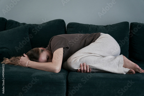 Woman with emotional problems lying on the couch