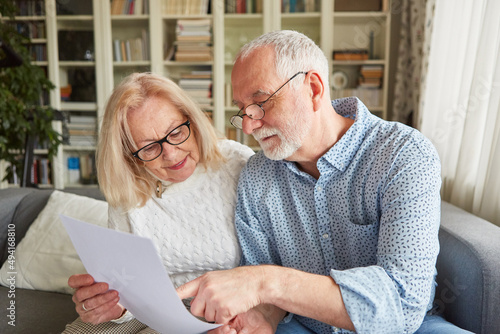 Senior couple reading an offer for retirement photo