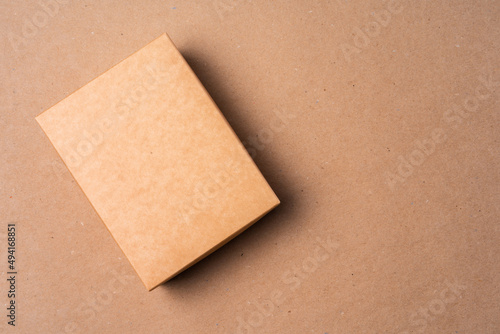Cardboard box on beige background in studio