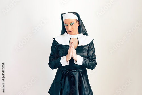 man disguised as a nun - crossdressing concept - drag queen performing - identity and religion clash photo