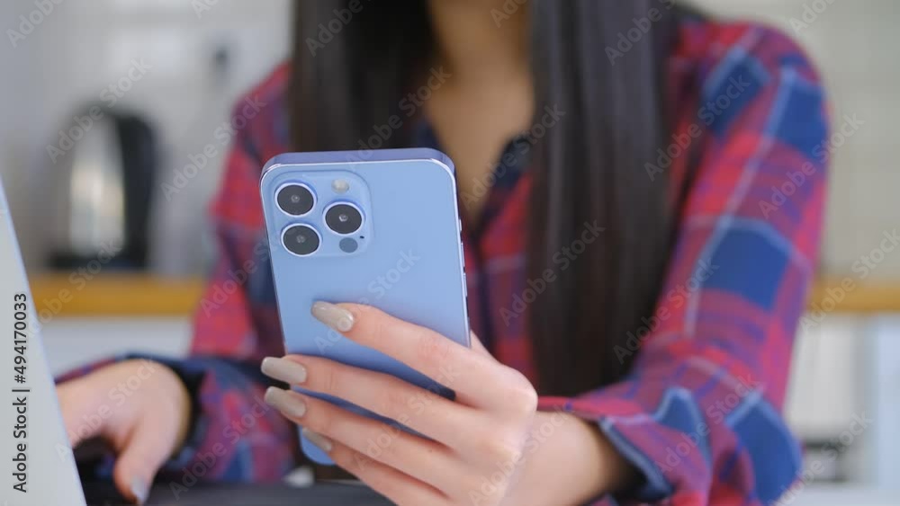Girl using modern mobile phone. Young female browsing internet on blue smartphone device with triple camera. Person use new cellphone for entertainment and communication online Girl using modern mobile phone. Young female browsing internet on blue smartphone device with triple camera. Person use new cellphone for entertainment and communication online