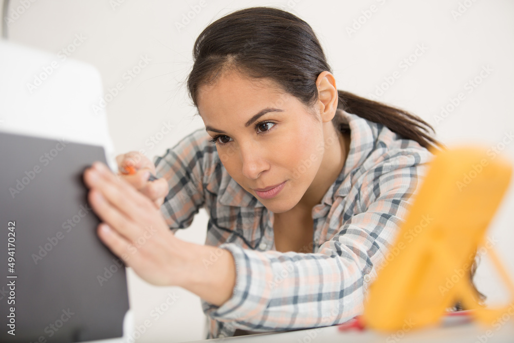 concentrated young woman fixing a desktop computer concentrated young woman fixing a desktop computer
