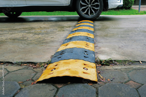 Canvas Print Slow down speed hump rubber ridge for car on concrete street