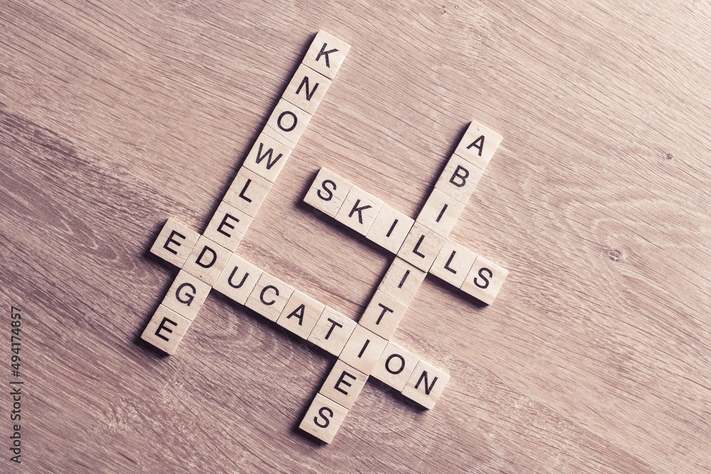 Conceptual keywords on wooden table with elements of game making crossword Conceptual keywords on wooden table with elements of game making crossword