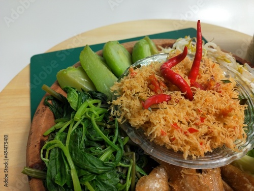 Urap is a traditional Indonesian dish in the form of cooked (boiled) vegetables mixed with seasoned grated coconut as a flavor enhancer photo