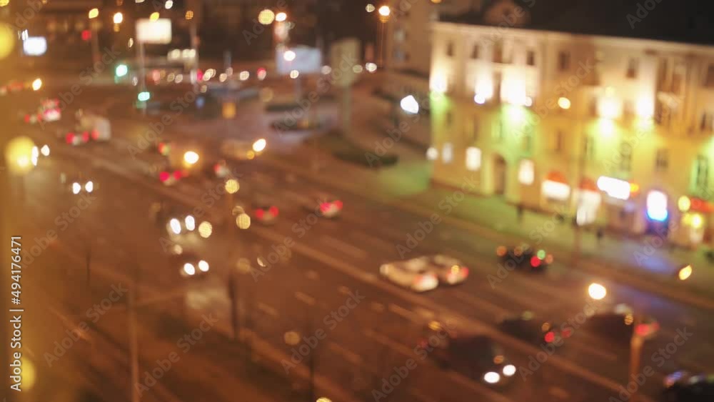 Blurred view from the window to the lights of the evening city and the busy traffic along the avenue. Bokeh effect Blurred view from the window to the lights of the evening city and the busy traffic along the avenue. Bokeh effect