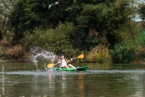Wallpaper Mural Happy bearded man in shirt and cap kayaking at the river with splashes. Copy space. The concept of watersport Torontodigital.ca