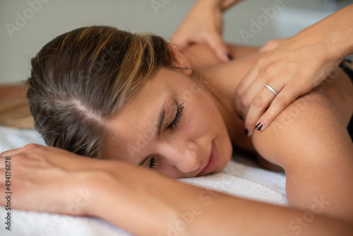 Woman relaxing shoulders massage spa