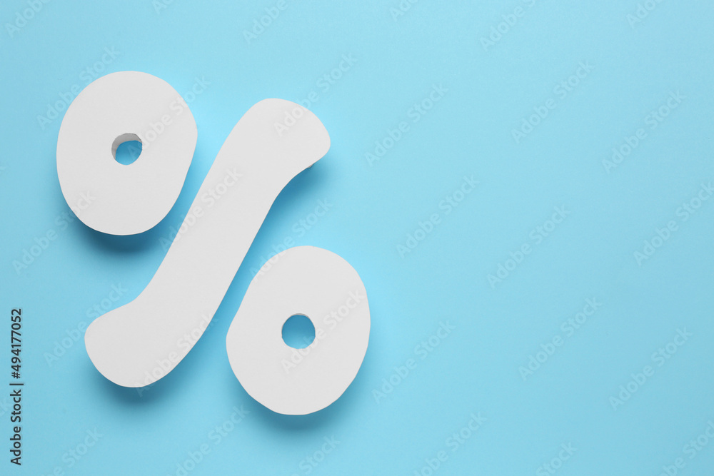 Percent sign on light blue background, flat lay. Space for text Percent sign on light blue background, flat lay. Space for text
