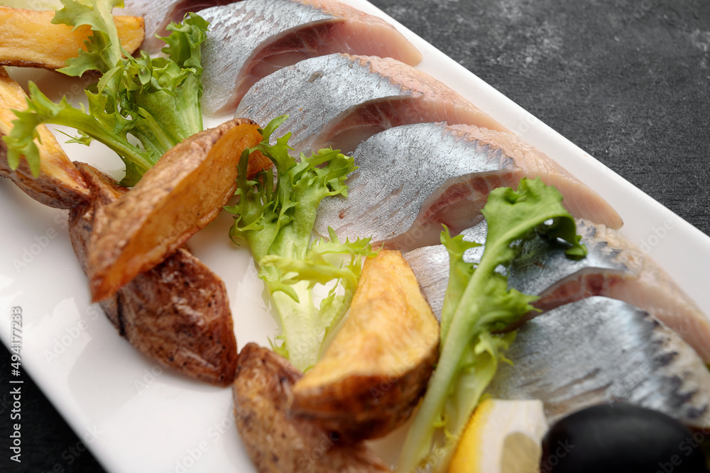 Pickled Herring with baked potatoes, onions and lettuce Pickled Herring with baked potatoes, onions and lettuce