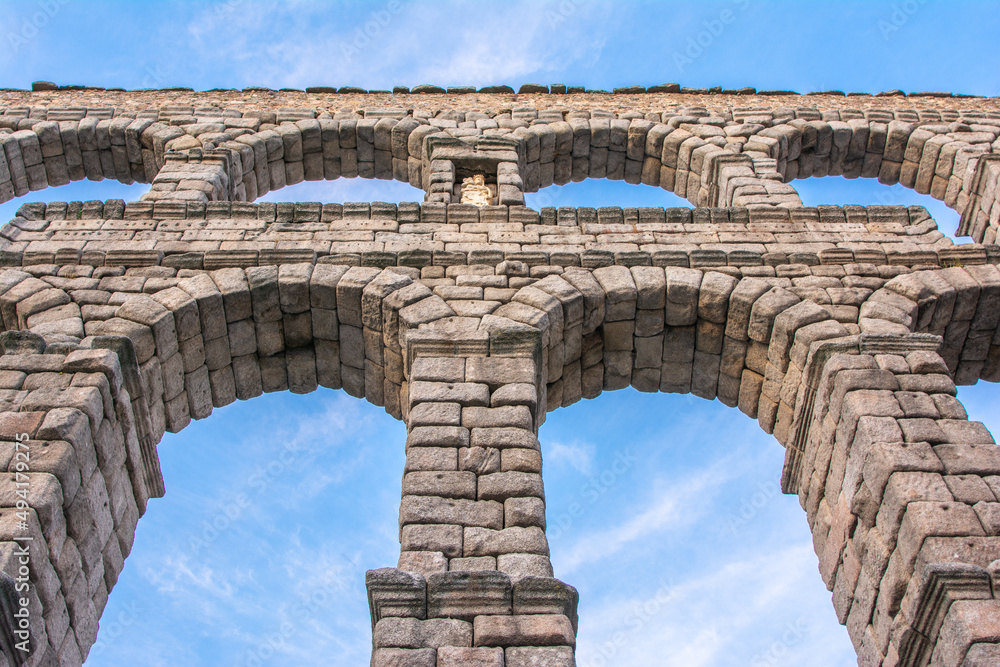 The famous Roman aqueduct of Segovia in Spain. Heritage of humanity by unesco. stone for the construction of a road