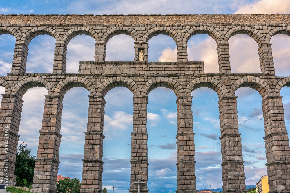 The famous Roman aqueduct of Segovia in Spain. Heritage of humanity by unesco. stone for the construction of a road The famous Roman aqueduct of Segovia in Spain. Heritage of humanity by unesco. stone for the construction of a road