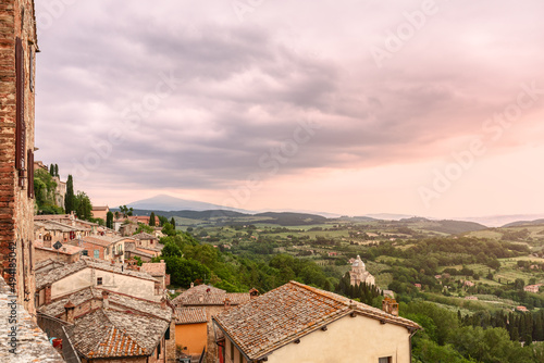 Panoramic view over tyled roofs of Montepulciano and the Dome of Sanctuary of the Madonna di San Biagio beneath to the Val d’Orcia, Tuscany, Italy photo