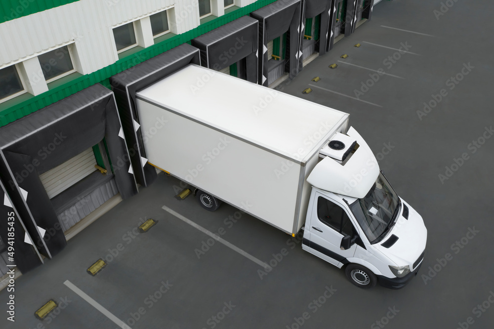 Truck near loading dock of warehouse outdoors, aerial view. Logistics center Truck near loading dock of warehouse outdoors, aerial view. Logistics center