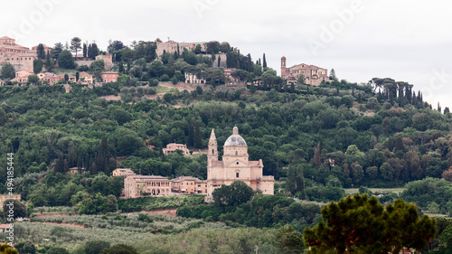 Sanctuary of the Madonna di San Biagio surrounded by forest and Montepulciano town behind on the hill, Siena, Italy 