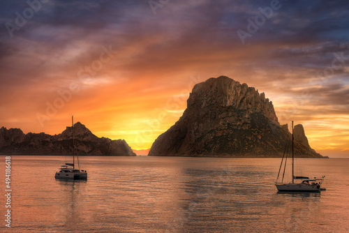  small rocky island situated on the south western side of Ibiza, Es Vedra is a 400 metre tall rock island that forms a part of the Cala d'Hort nature reserve.  photo