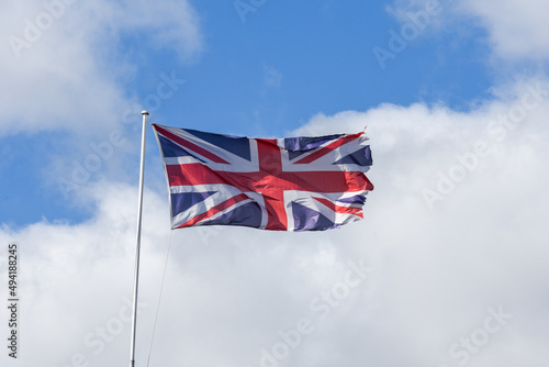 Union Jack flag of United Kingdom flyiing with ripped edges