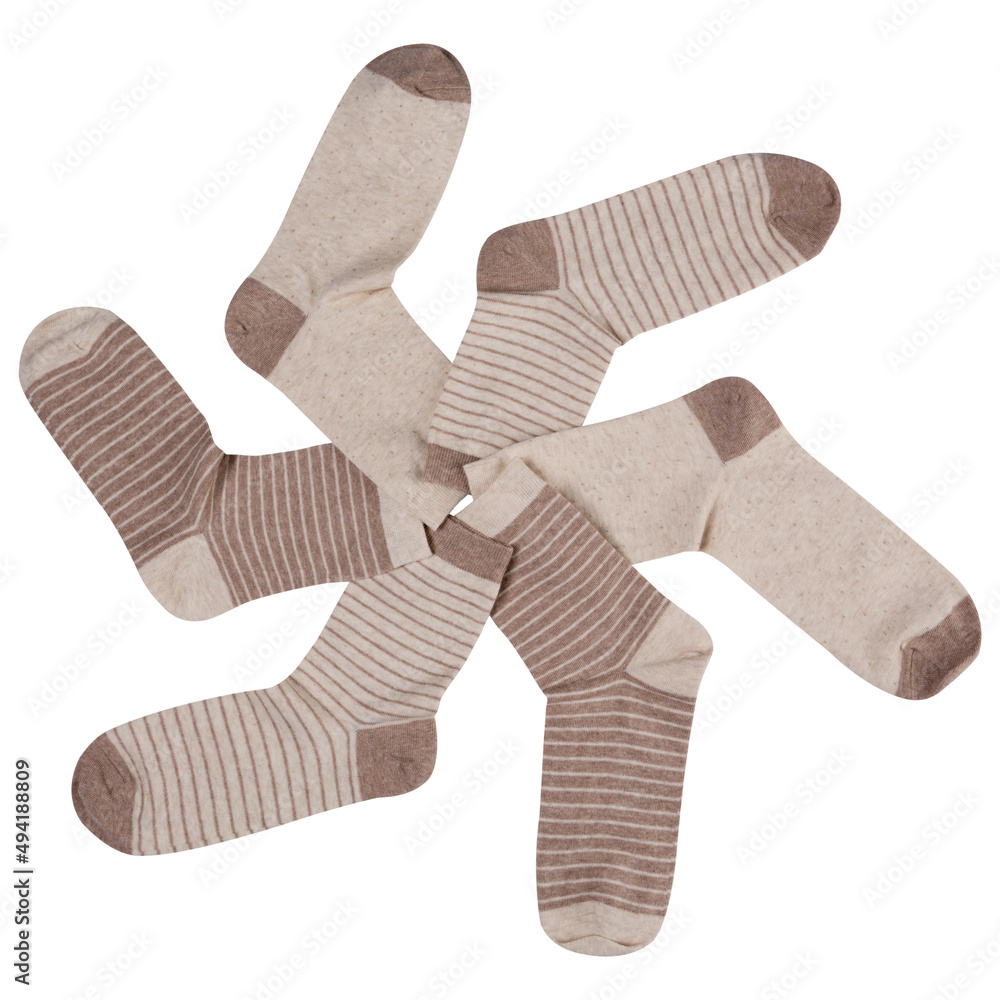 six beige striped socks laid out in a circle, like a propeller or a wheel, on a white background six beige striped socks laid out in a circle, like a propeller or a wheel, on a white background