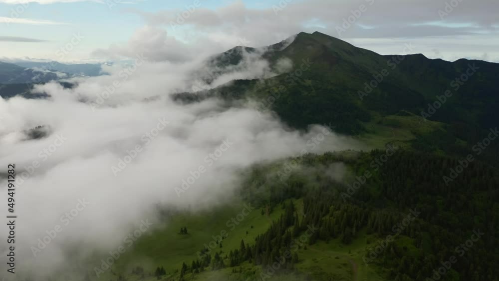 Spectacular mountain range is shrouded in fog. Filmed in UHD 4k video. Spectacular mountain range is shrouded in fog. Filmed in UHD 4k video.