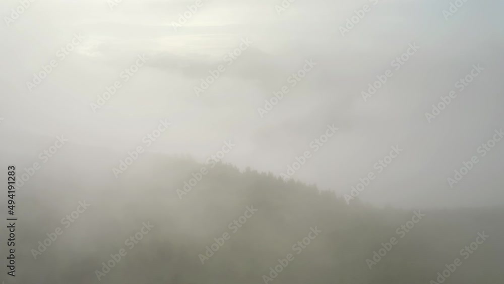 Mountain peaks can be seen above the clouds of thick fog. Filmed in UHD 4k video. Mountain peaks can be seen above the clouds of thick fog. Filmed in UHD 4k video.