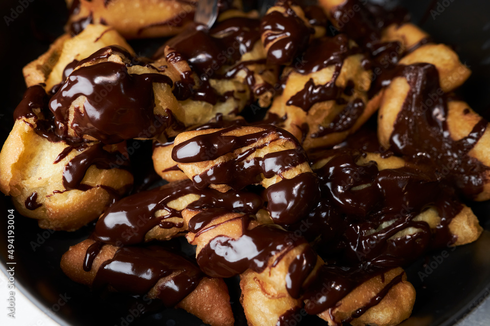 eclairs with custard drizzled with chocolate. Eclair with custard