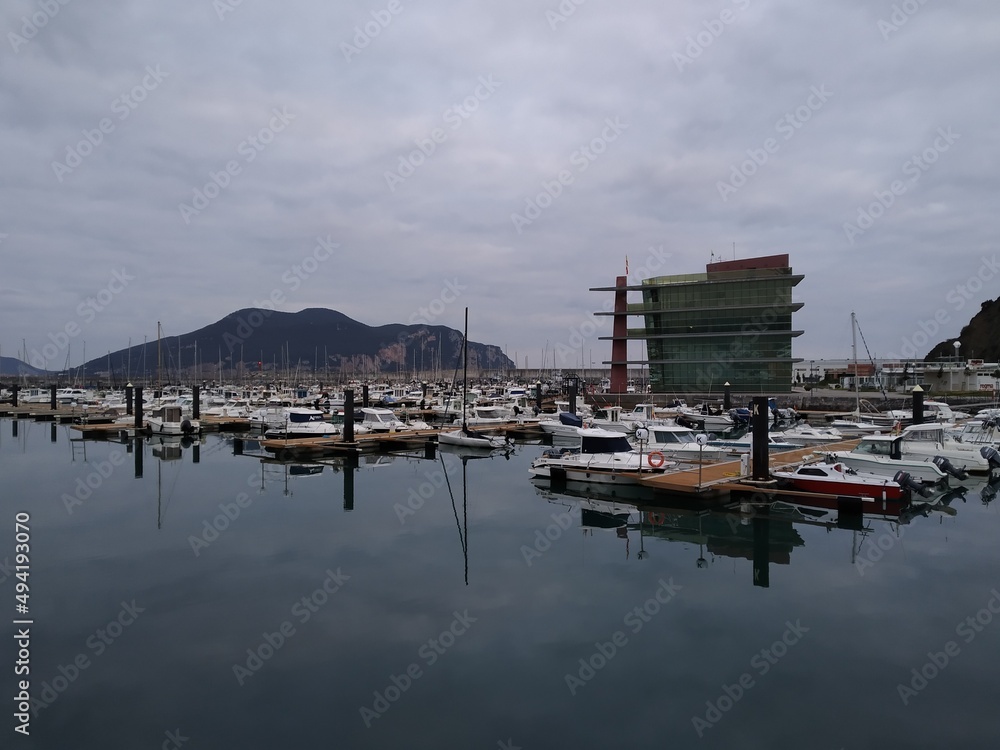 Fototapeta premium Marina with boats moored on a cloudy day. Horizontal view. 