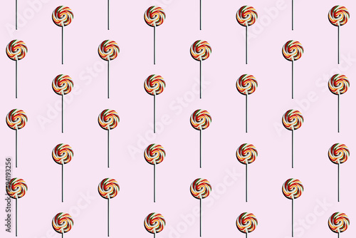 pink background of candy lollipop sweet with stick, delicious and fun food with colorful sugar © Pixel_Studio_8