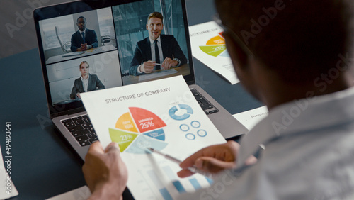 Young businessman makes conference video call on laptop computer. Webcam company team meeting