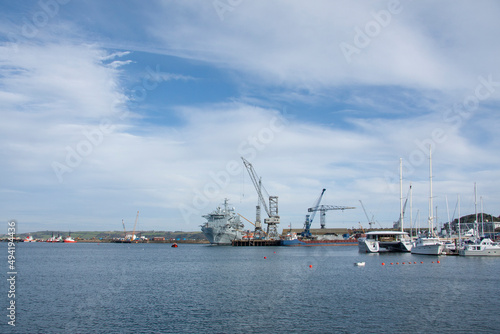 cranes and ships along side the loading bays at Birkenhead docks blue sea and sky seascape no people nobody © © Raymond Orton