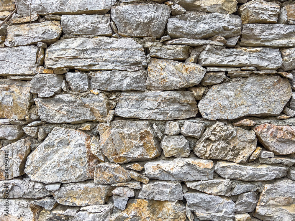 Stone wall texture. Part of old rocky hand crafted background with copy space. Walls made of natural bricks. High quality photo. Home and office design backdrop Stone wall texture. Part of old rocky hand crafted background with copy space. Walls made of natural bricks. High quality photo. Home and office design backdrop