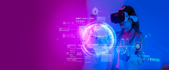Young woman using glasses of virtual reality on dark background. Smartphone using with VR headset,virtual reality,future technology concept.Asian woman using VR glasses in colorful neon lights.