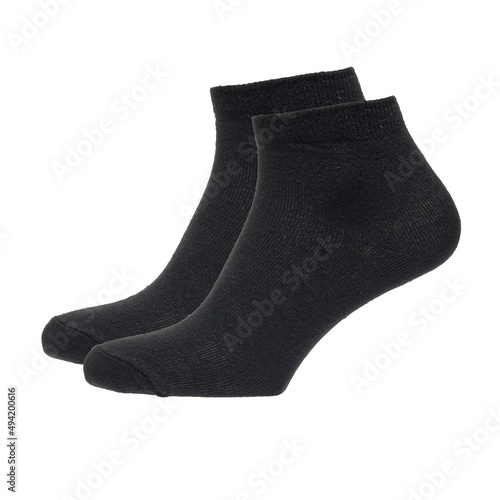 A pair of fabric socks stands on a white isolated background. Volumetric socks on a transparent mannequin. Black men's socks.