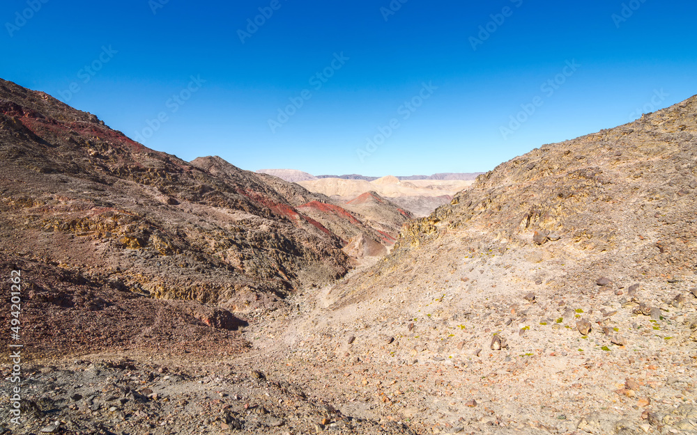 The trail goes through a rocky desert canyon. The trail goes through a rocky desert canyon.