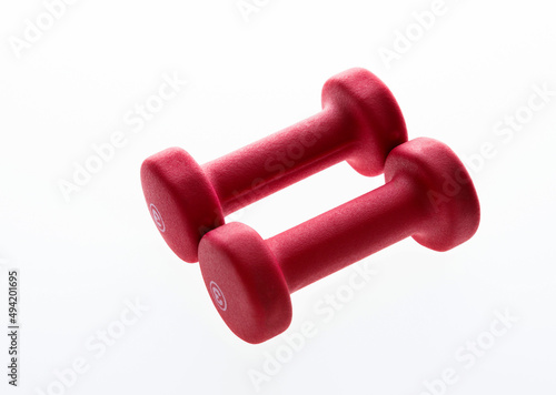 Pair of red dumbbells isolated on white